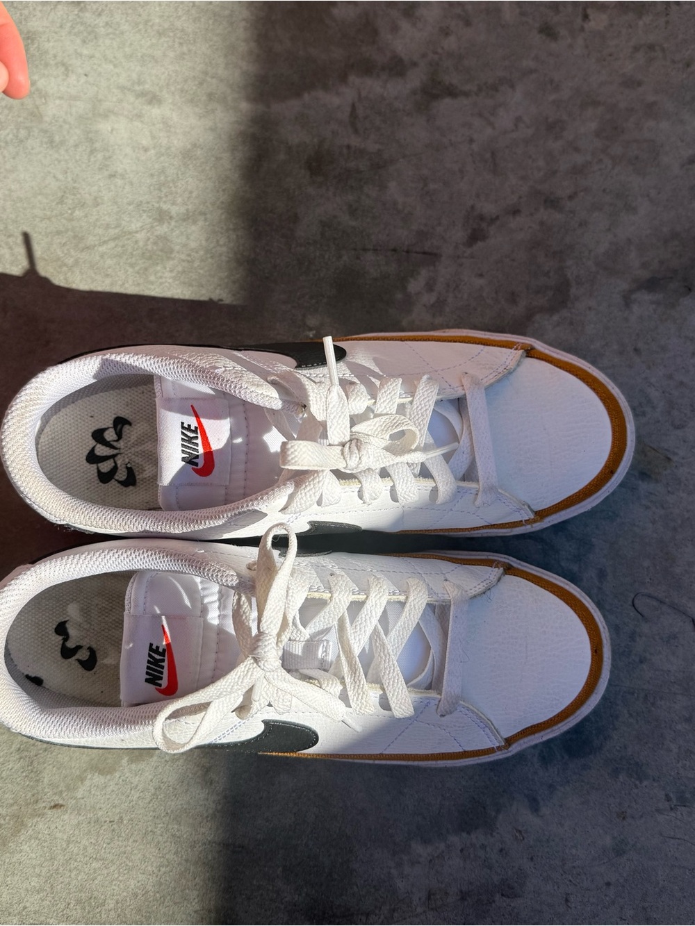 Nike White Sneakers with Brown Trim and Black Swoosh